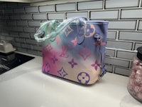 a louis vuitton tote bag sitting on a counter