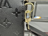 a louis vuitton bag with a lock on it