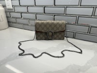 the guccissi mini crossbody bag is sitting on a counter