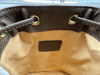 the inside of a brown leather bag