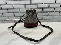 a gucci bucket bag sitting on a counter