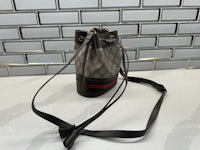 a gucci bucket bag sitting on a counter