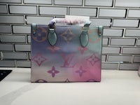 a louis vuitton handbag sitting on a counter