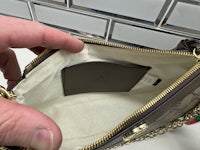 a person holding a purse with a zipper on it