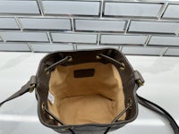 a small brown bucket bag sitting on a counter