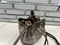 the gucci bucket bag is sitting on a counter